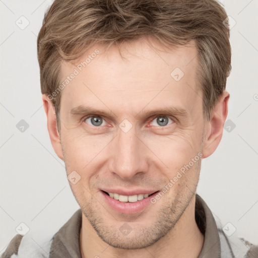 Joyful white adult male with short  brown hair and grey eyes