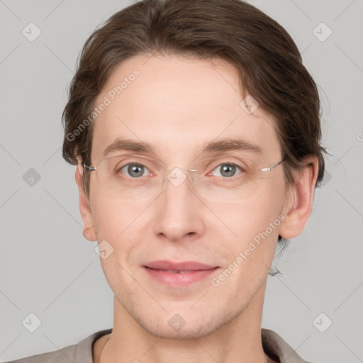 Joyful white young-adult male with short  brown hair and grey eyes