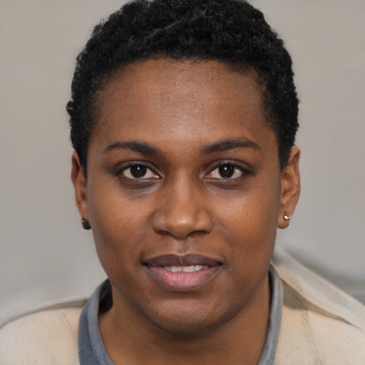 Joyful black young-adult female with short  black hair and brown eyes