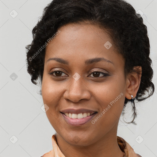 Joyful black young-adult female with long  brown hair and brown eyes