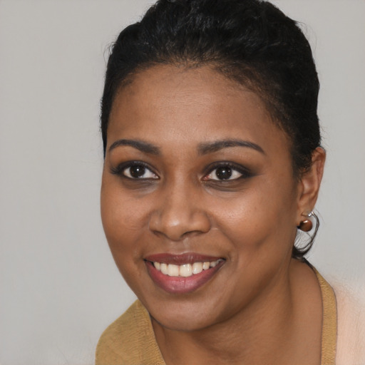 Joyful black young-adult female with short  brown hair and brown eyes