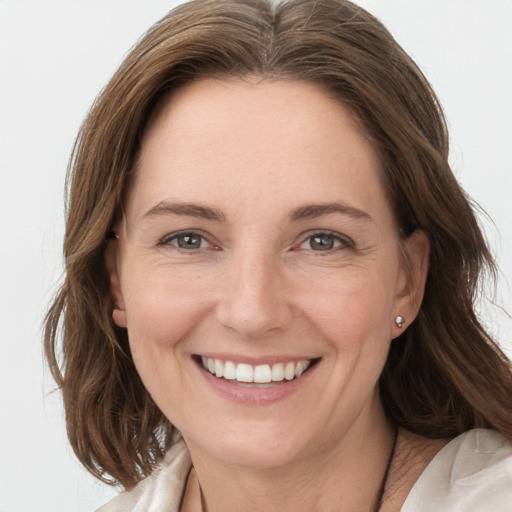 Joyful white young-adult female with medium  brown hair and grey eyes