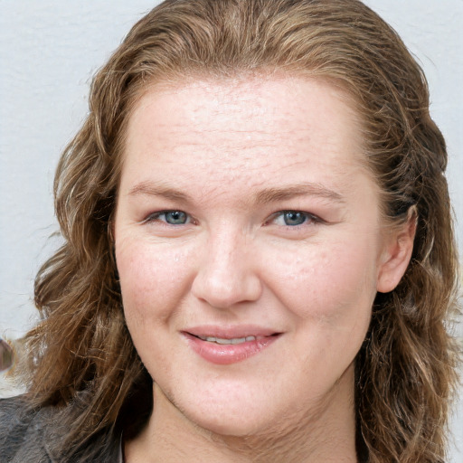 Joyful white adult female with long  brown hair and grey eyes