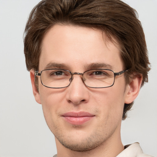 Joyful white young-adult male with short  brown hair and grey eyes