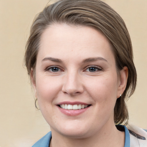 Joyful white young-adult female with medium  brown hair and grey eyes