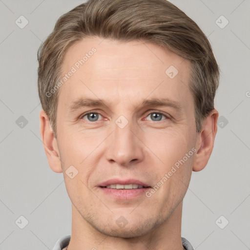 Joyful white adult male with short  brown hair and grey eyes