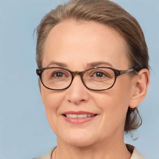 Joyful white adult female with medium  brown hair and brown eyes