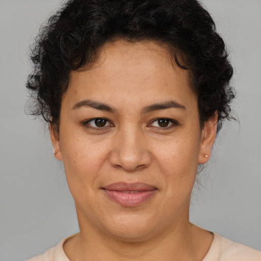 Joyful latino adult female with short  brown hair and brown eyes
