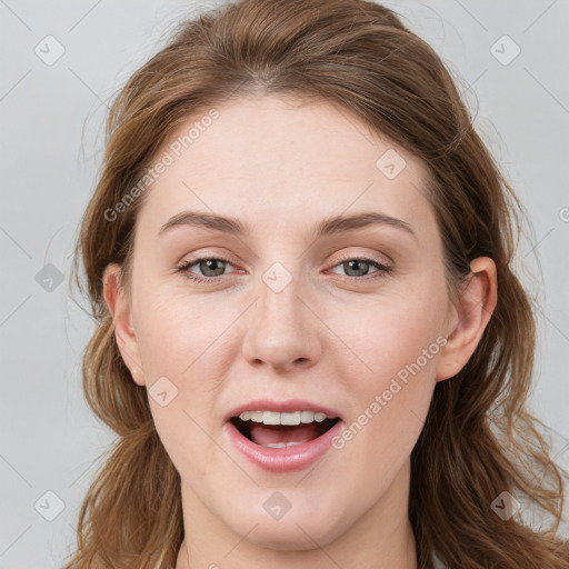 Joyful white young-adult female with long  brown hair and blue eyes