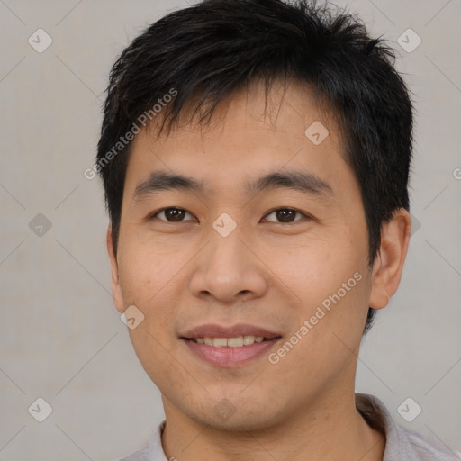 Joyful asian young-adult male with short  brown hair and brown eyes