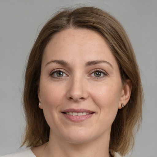 Joyful white adult female with medium  brown hair and grey eyes