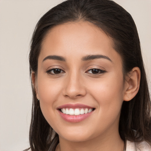 Joyful white young-adult female with long  brown hair and brown eyes