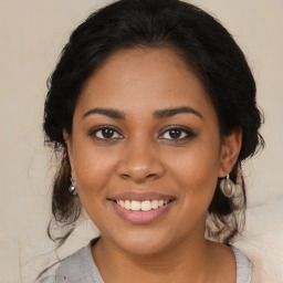 Joyful black young-adult female with medium  brown hair and brown eyes