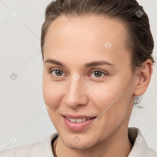 Joyful white young-adult female with short  brown hair and brown eyes