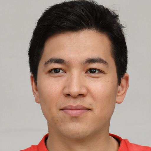 Joyful asian young-adult male with short  black hair and brown eyes