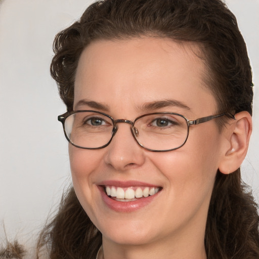 Joyful white young-adult female with medium  brown hair and grey eyes