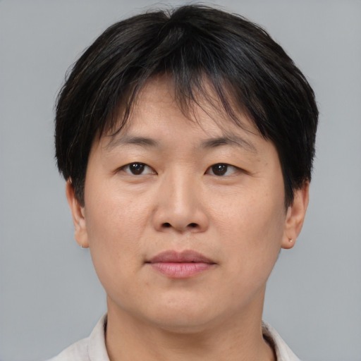 Joyful asian adult female with short  brown hair and brown eyes