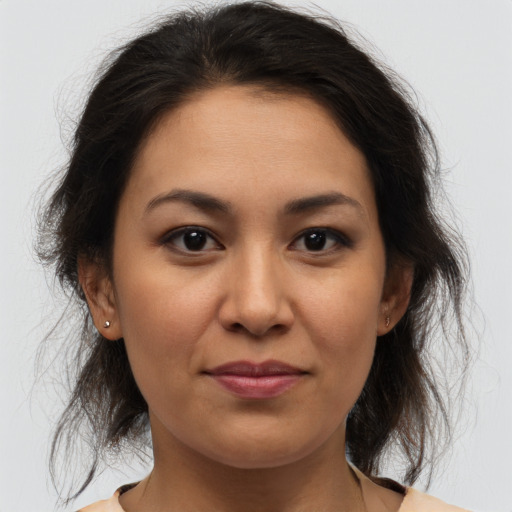 Joyful latino young-adult female with medium  brown hair and brown eyes