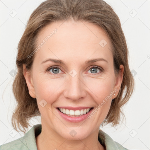 Joyful white adult female with medium  brown hair and grey eyes