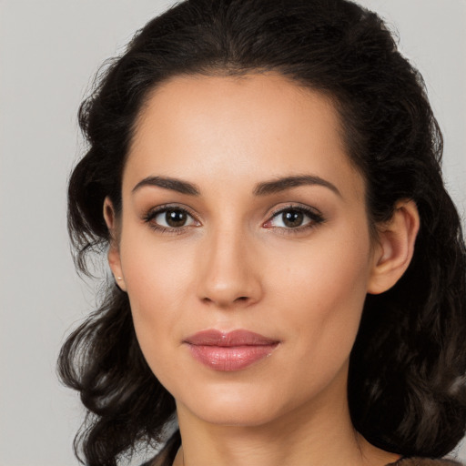 Joyful latino young-adult female with long  brown hair and brown eyes