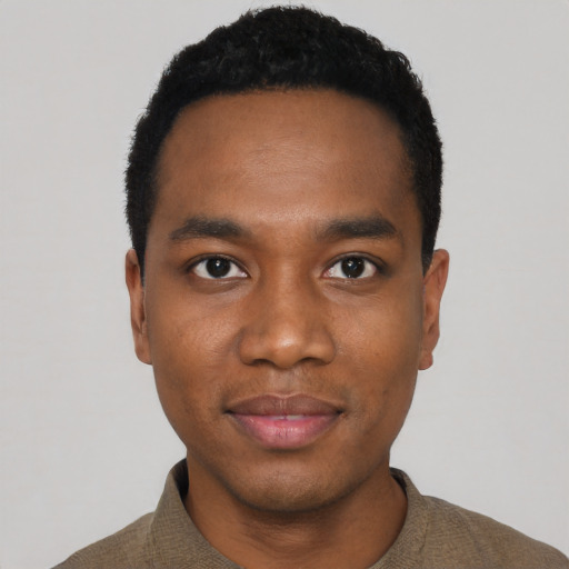 Joyful black young-adult male with short  black hair and brown eyes