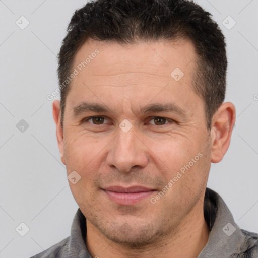 Joyful white adult male with short  brown hair and brown eyes