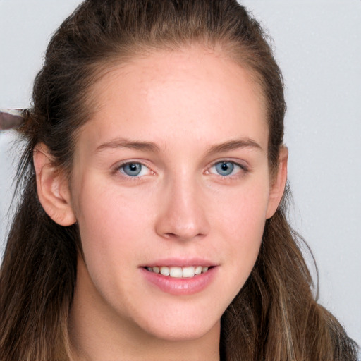 Joyful white young-adult female with long  brown hair and grey eyes