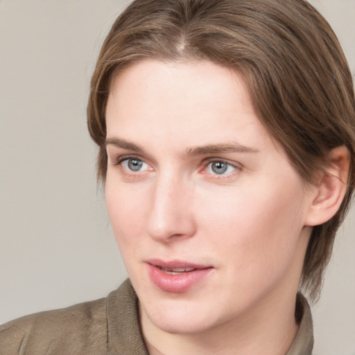 Joyful white young-adult female with medium  brown hair and blue eyes