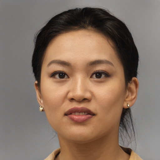Joyful asian young-adult female with short  brown hair and brown eyes