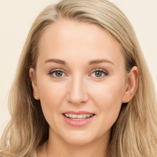 Joyful white young-adult female with long  brown hair and blue eyes