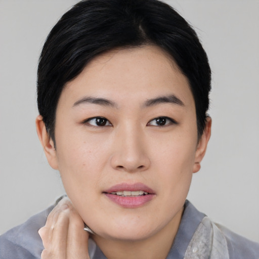 Joyful asian young-adult female with short  black hair and brown eyes