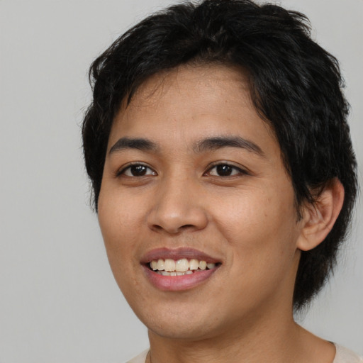 Joyful asian young-adult female with short  brown hair and brown eyes