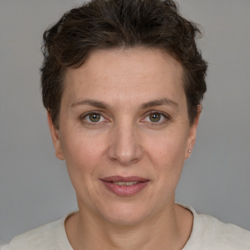 Joyful white adult female with short  brown hair and grey eyes