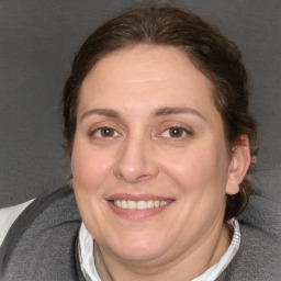 Joyful white adult female with medium  brown hair and brown eyes