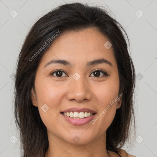 Joyful latino young-adult female with long  brown hair and brown eyes