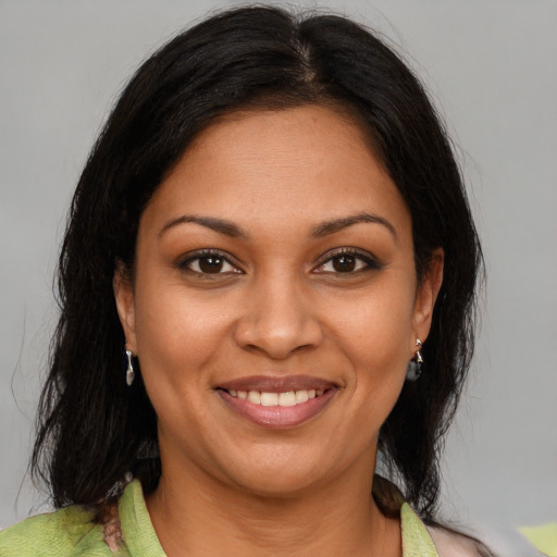 Joyful black young-adult female with medium  brown hair and brown eyes