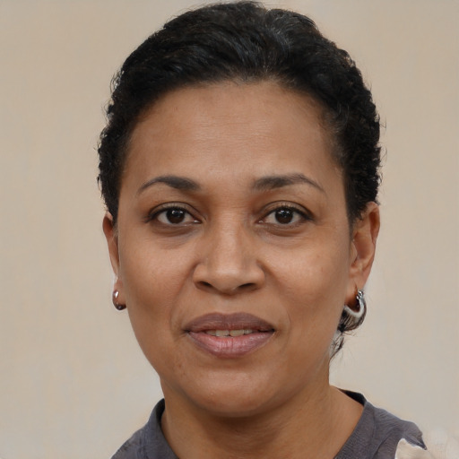 Joyful latino adult female with short  black hair and brown eyes