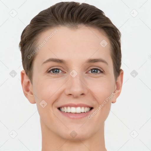 Joyful white young-adult female with short  brown hair and grey eyes