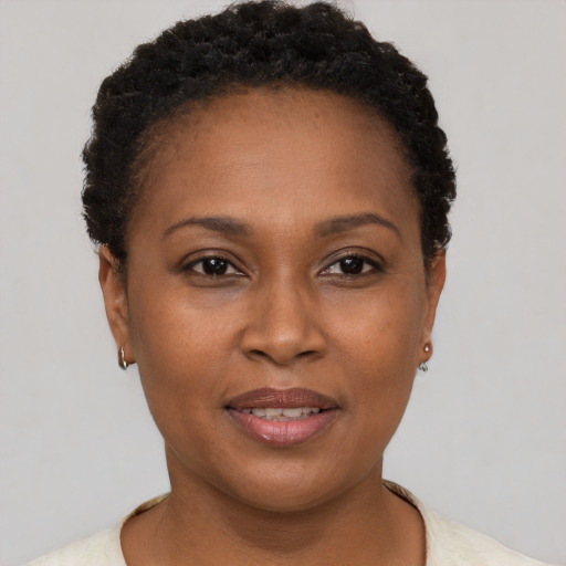 Joyful black young-adult female with short  brown hair and brown eyes
