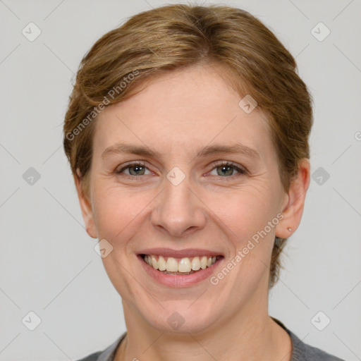 Joyful white adult female with short  brown hair and grey eyes