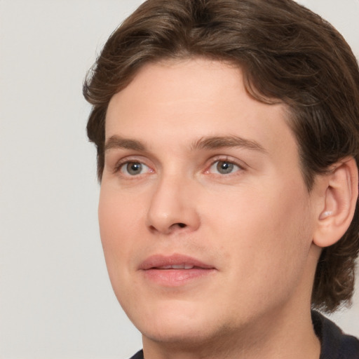 Joyful white young-adult male with medium  brown hair and brown eyes