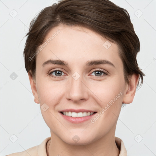 Joyful white young-adult female with short  brown hair and grey eyes