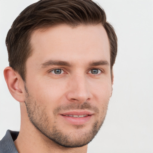 Joyful white young-adult male with short  brown hair and grey eyes