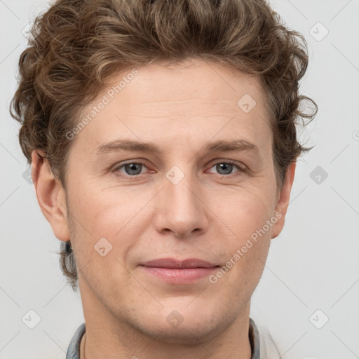 Joyful white adult male with short  brown hair and grey eyes