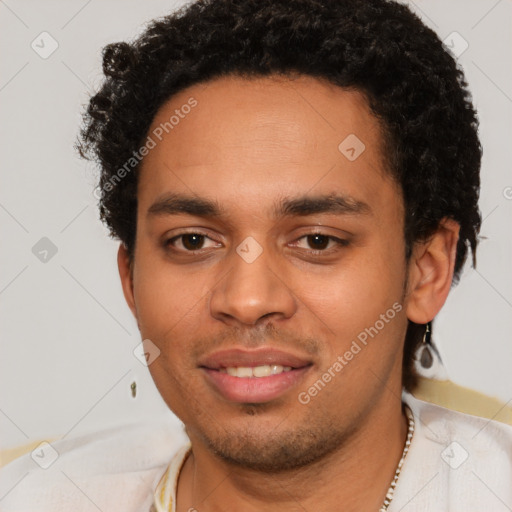 Joyful latino young-adult male with short  brown hair and brown eyes