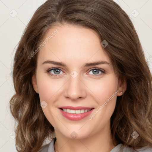 Joyful white young-adult female with long  brown hair and green eyes