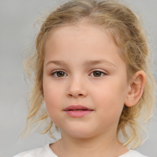 Joyful white child female with medium  brown hair and brown eyes