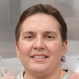 Joyful white adult female with medium  brown hair and grey eyes