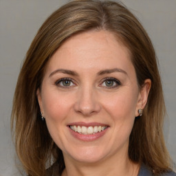 Joyful white adult female with medium  brown hair and brown eyes