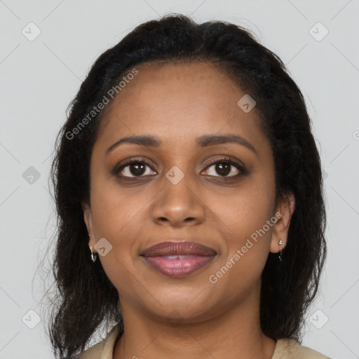 Joyful black young-adult female with long  brown hair and brown eyes